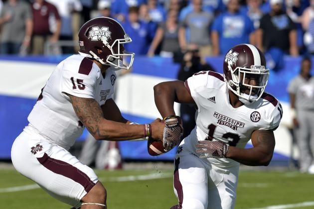 Mississippi State's Dak Prescott, left, fakes a handoff to Josh Robinson during the second quarter of an NCAA college football game at Commonwealth Stadium in Lexington, Ky., Saturday, Oct. 25, 2014. (AP Photo/Timothy D. Easley)