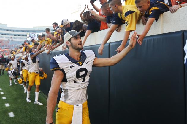 West Virginia quarterback Clint Trickett (9) greets fans following an NCAA college football game in Stillwater, Okla., Saturday, Oct. 25, 2014. West Virginia defeated Oklahoma State 34-10. (AP Photo/Sue Ogrocki)