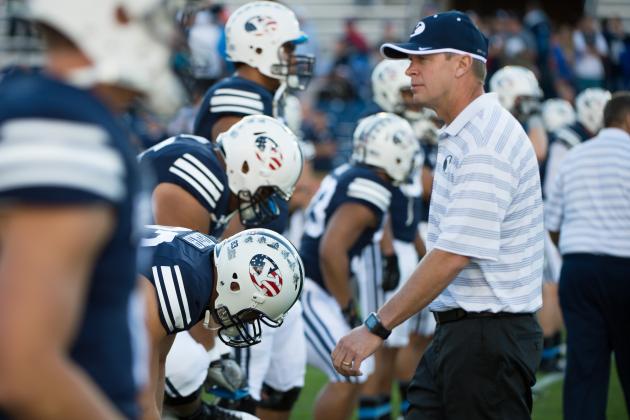PROVO, UT - SEPTEMBER 11:  Head coach Bronco Mendenhall of the BYU Cougars walk through a group of players warming up before a game against the Houston Cougars on September 11, 2014 at LaVell Edwards Stadium in Provo, Utah. (Photo by Jay Drowns/Getty Images)