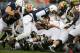Penn State quarterback Christian Hackenberg (14) gets a first down on a quarterback sneak during the first quarter of an NCAA college football game against Maryland in State College, Pa., Saturday, Nov. 1, 2014. (AP Photo/Gene J. Puskar)