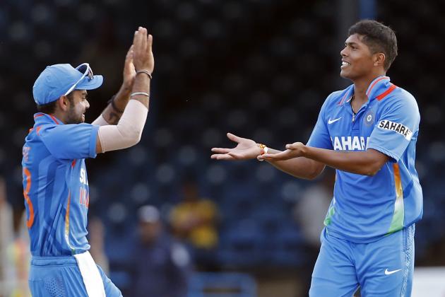 India's acting captain Virat Kohli, left, congratulates bowler Umesh Yadav after he took the wicket of Sri Lanka's Lasith Malinga during their Tri-Nation Series cricket match in Port-of-Spain, Trinidad, Tuesday, July 9, 2013. India won by 81 runs under the Duckworth/Lewis method and both teams will meet again in the final on Thursday. (AP Photo/Andres Leighton)