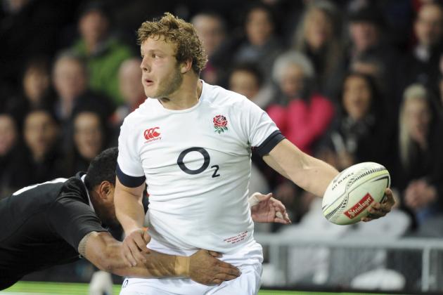 England’s Joe Launchbury passes the ball in field in a New Zealand tackle in the second international rugby test match at Forsyth Barr Stadium in Dunedin, New Zealand, Saturday, June 14, 2014.(AP Photo/SNPA, Ross Setford) NEW ZEALAND OUT