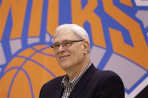 FILE - In this June 10, 2014, file photo, New York Knicks president Phil Jackson smiles during a news conference in Tarrytown, N.Y. Jackson hears the question every time he walks around New York: How are the Knicks going to do? The Knicks' President answers this way:
