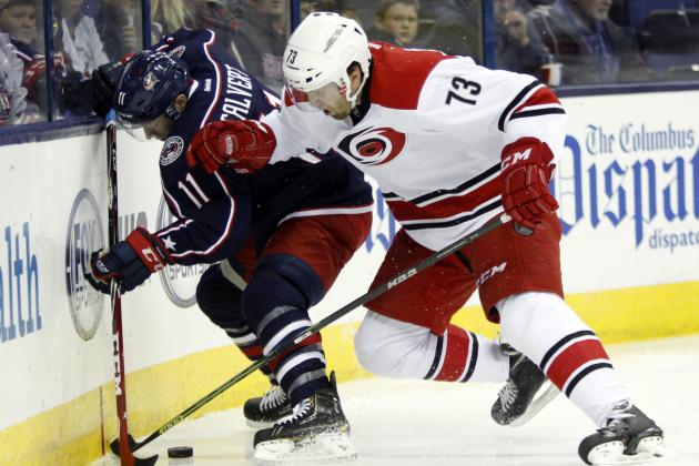 Columbus Blue Jackets' Matt Calvert, left, works for the puck against Carolina Hurricanes' Brett Bellemore during the second period of an NHL hockey game in Columbus, Ohio, Tuesday, Nov. 4, 2014. (AP Photo/Paul Vernon)