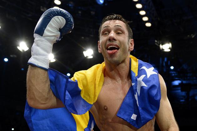 Challenger Felix Sturm from Germany celebrates his victory after his middleweight title bout against Darren Barker of Britain in Stuttgart, southern Germany, Saturday, Dec. 7, 2013. Sturm defeated defending champion Barker with a second round TKO to take the Briton's IBF middleweight title on Saturday. (AP Photo/Daniel Kopatsch)