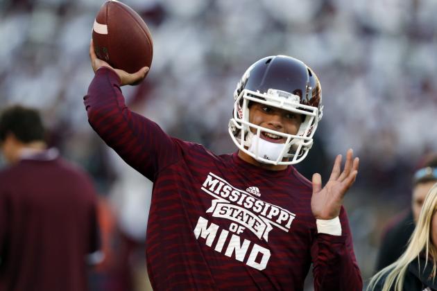 Mississippi State quarterback Dak Prescott  throws during pregame warm ups of an NCAA college football game against Arkansas in Starkville, Miss., Saturday, Nov. 1, 2014. (AP Photo/Rogelio V. Solis)