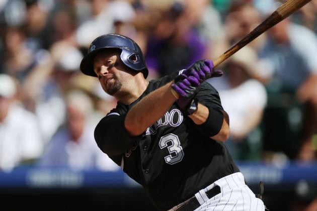 Colorado Rockies' Michael Cuddyer swings at a pitch against the Cincinnati Reds in the third inning of a baseball game in Denver, Sunday, Aug. 17, 2014. (AP Photo/David Zalubowski)