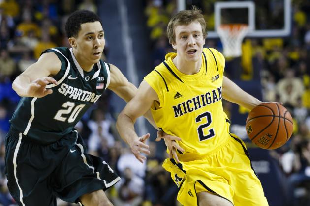 Feb 23, 2014; Ann Arbor, MI, USA; Michigan Wolverines guard Spike Albrecht (2) moves the ball defended by Michigan State Spartans guard Travis Trice (20) in the first half at Crisler Arena. Mandatory Credit: Rick Osentoski-USA TODAY Sports