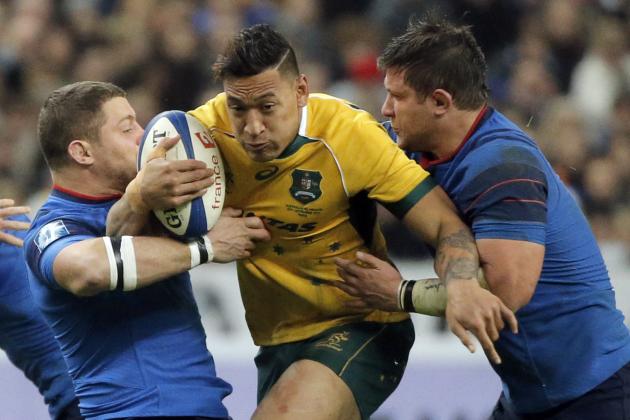 France rugby player Scott Spedding of South Africa, third right, and Prop Alexandre Menini, right, tackle Australia Israel Folau, second right, during their rugby union international match at the Stade De France in Saint Denis, north of Paris, Saturday Nov. 15, 2014. (AP Photo/Francois Mori)