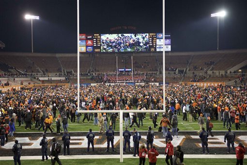 Oregon State football fans rush the field at the end of an NCAA college football game against Arizona State in Corvallis, Or., Saturday, Nov. 15, 2014. The Beavers beat the Sun Devils 35-27. (AP Photo/Troy Wayrynen)