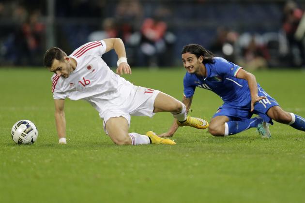 Italy's Alberto Aquilani, right, challenges for the ball with Albania's Sokol Cikalleschi during the friendly soccer match between Italy and Albania, at the Luigi Ferraris stadium in Genoa, Italy, Tuesday, Nov. 18, 2014. (AP Photo/Antonio Calanni)