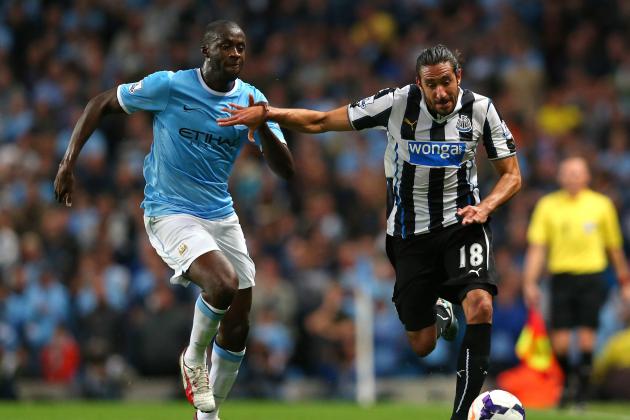 MANCHESTER, ENGLAND - AUGUST 19:  Jonas Gutierrez of Newcastle United holds off a challenge from Yaya Toure of Manchester City during the Barclays Premier League match between Manchester City and Newcastle United at the Etihad Stadium on August 19, 2013 in Manchester, England.  (Photo by Alex Livesey/Getty Images)