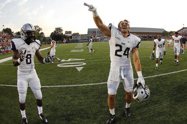 Sep 20, 2014; Richmond, VA, USA; New Hampshire Wildcats wide receiver Mike Kelly (24) and running back Trevon Bryant (8) celebrate after their game against the Richmond Spiders at Robins Stadium. The Wildcats won 29-26. Mandatory Credit: Geoff Burke-USA TODAY Sports
