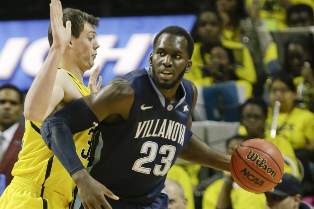 Michigan's Ricky Doyle, left, defends Villanova's Daniel Ochefu (23) during the first half of an NCAA college basketball game Tuesday, Nov. 25, 2014, in New York. (AP Photo/Frank Franklin II)
