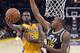 Los Angeles Lakers forward Earl Clark, left, puts up a shot as Utah Jazz forward Derrick Favors defends during the first half of an NBA basketball game, Friday, Jan. 25, 2013, in Los Angeles. (AP Photo/Mark J. Terrill)