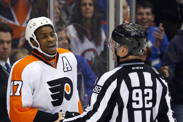 Philadelphia Flyers right wing Wayne Simmonds (17) yells at a referee as linesman Mark Shewchyk (92) restrains him after Simmonds was penalized for boarding in the third period of an NHL hockey game against the New York Islanders at Nassau Coliseum in Uniondale, N.Y., Monday, Nov. 24, 2014. The Islanders won 1-0 in a shootout. (AP Photo/Kathy Willens)