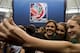 Team Canada's Christine Sinclair takes a photo with young soccer fans as FIFA unveils the official emblem for the 2015 Women's World Cup soccer tournament during a ceremony in downtown Vancouver, British Columbia Friday, Dec. 14, 2012. (AP Photo/The Canadian Press, Jonathan Hayward)