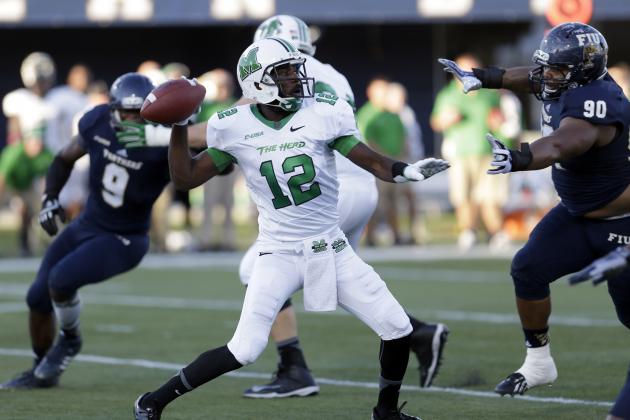 Marshall quarterback Rakeem Cato (12) prepares to pass against Florida International during the first half of an NCAA college football game, Saturday, Oct. 18, 2014, in Miami. (AP Photo/Alan Diaz)