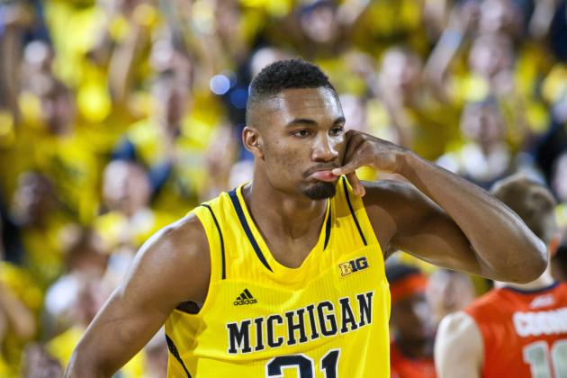 Michigan guard Zak Irvin (21) reacts after scoring a basket in the first half of an NCAA college basketball game against Syracuse at Crisler Center in Ann Arbor, Mich., Tuesday, Dec. 2, 2014. (AP Photo/Tony Ding)