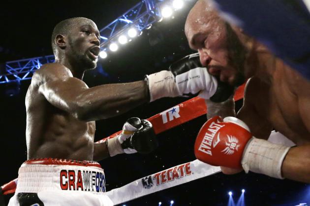 Terence Crawford, left, lands a punch on Raymundo Beltran during a WBO lightweight title boxing bout in Omaha, Neb., early Sunday, Nov. 30, 2014. Crawford defended his title. (AP Photo/Nati Harnik)