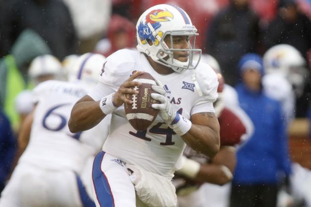 NORMAN, OK - NOVEMBER 22:  Quarterback Michael Cummings #14 of the Kansas Jayhawks looks to throw against the Oklahoma Sooners November 22, 2014 at Gaylord Family-Oklahoma Memorial Stadium in Norman, Oklahoma. The Sooners defeated the Jayhawks 44-7.  (Photo by Brett Deering/Getty Images)