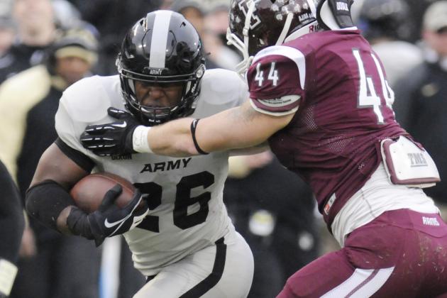 Army running back Larry Dixon (26) is defended by Fordham linebacker Austin Hancock (44) during the second half of an NCAA college football game on Saturday, Nov. 22, 2014, in West Point, N.Y. (AP Photo/Hans Pennink)