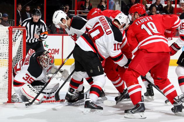 RALEIGH, NC - DECEMBER 08: Cory Schneider #35 of the New Jersey Devils makes a save through traffic in front of the net during their NHL game against the Carolina Hurricanes at PNC Arena on December 8, 2014 in Raleigh, North Carolina.  (Photo by Gregg Forwerck/NHLI via Getty Images)