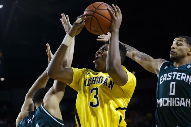 Dec 9, 2014; Ann Arbor, MI, USA; Michigan Wolverines guard/forward Kameron Chatman (3) shoots the ball in front of forward Karrington Ward (14) and Eastern Michigan Eagles guard Raven Lee (0) in the first half at Crisler Center. Mandatory Credit: Rick Osentoski-USA TODAY Sports