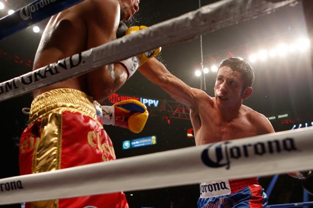 LAS VEGAS, NV - JULY 12:  (R-L) Mauricio Herrera lands a right to the head of Johan Perez during their interim WBA junior welterweight title bout at the MGM Grand Garden Arena on July 12, 2014 in Las Vegas, Nevada.  Herrera took Perez's title by majority decision.  (Photo by Josh Hedges/Getty Images)