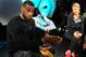 LeBron James, answers a question from members of the media as Kristen Ledlow looks on during the introduction of the LeBron 12 shoe at the Nike World Headquarters in Beaverton, Ore., on Tuesday, Sept. 16, 2014. (AP Photo/Steve Dykes)