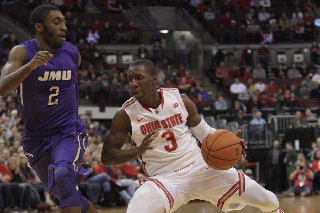 Ohio State's Shannon Scott, right, drives to the basket against James Madison's Ron Curry during the first half of an NCAA college basketball game Friday, Nov. 28, 2014, in Columbus, Ohio. (AP Photo/Jay LaPrete)