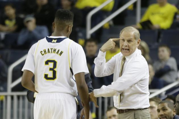 Michigan head coach John Beilein talks with guard Kameron Chatman during the first half of an NCAA college basketball game against Nicholls State in Ann Arbor, Mich., Saturday, Nov. 29, 2014. (AP Photo/Carlos Osorio)