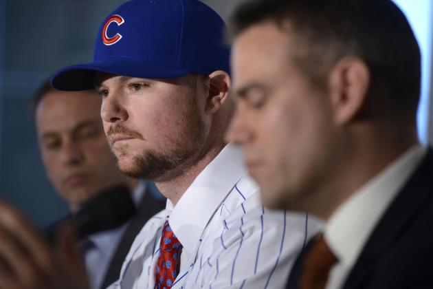 Pitcher Jon Lester center, listens as Chicago Cubs President of Baseball Operations Theo Epstein right, speaks to the media and Vice President of Baseball Operations and General Manager Jeb Hoyer left, looks on after Lester was introduced as a member of the Chicago Cubs during a press conference in Chicago, Monday, Dec. 15, 2014. (AP Photo/Paul Beaty)