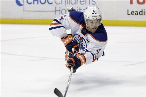 Edmonton Oilers' Taylor Hall dives for the puck during the third period of an NHL hockey game against the Anaheim Ducks, Wednesday, Dec. 10, 2014, in Anaheim, Calif. The Ducks won 2-1. (AP Photo/Jae C. Hong)