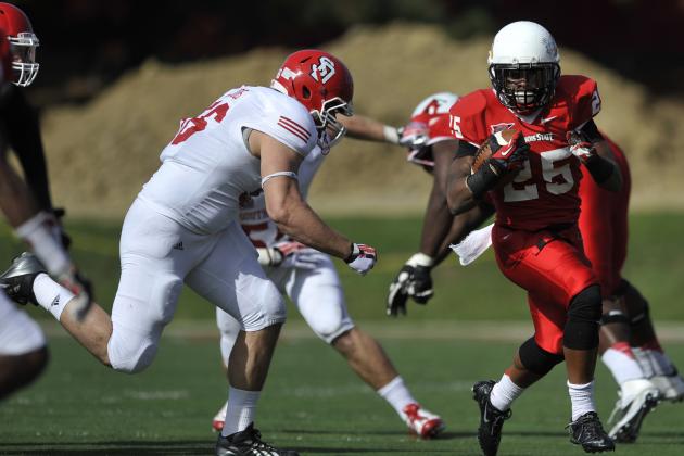 Illinois State running back Marshaun Coprich (25) rushes against South Dakota's Nick Jacobs (56) during the first half of an NCAA college football game in Normal, Ill., Saturday, Oct. 26, 2013. Illinois State won 28-14. (AP Photo/Paul Beaty)