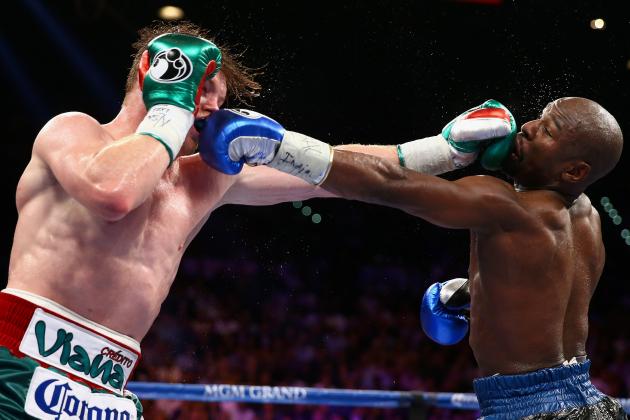 LAS VEGAS, NV - SEPTEMBER 14:  (L-R) Floyd Mayweather Jr. and Canelo Alvarez exchange punches during their WBC/WBA 154-pound title fight at the MGM Grand Garden Arena on September 14, 2013 in Las Vegas, Nevada.  (Photo by Al Bello/Getty Images)