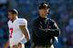 CHARLOTTE, NC - JANUARY 12: Head coach Jim Harbaugh of the San Francisco 49ers looks on in the second quarter as Colin Kaepernick #7 walks by against the Carolina Panthers during the NFC Divisional Playoff Game at Bank of America Stadium on January 12, 2014 in Charlotte, North Carolina. (Photo by Ronald Martinez/Getty Images)