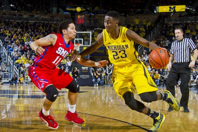 Southern Methodist guard Nic Moore (11) defends Michigan guard Caris LeVert (23) in the second half of an NCAA college basketball game at Crisler Center in Ann Arbor, Mich., Saturday, Dec. 20, 2014. Southern Methodist won 61-51. (AP Photo/Tony Ding)