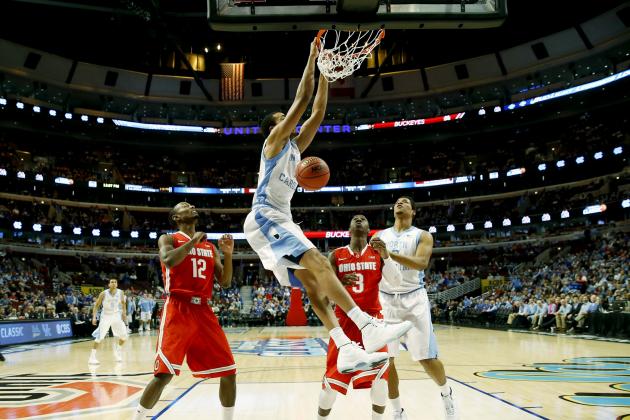 North Carolina forward Brice Johnson (11) dunks as forward Kennedy Meeks (3) and Ohio State forward Sam Thompson (12), guard Shannon Scott (3) look on during the first half of an NCAA college basketball game in CBS Sports Classic on Saturday, Dec. 20, 2014, in Chicago. (AP Photo/Charles Rex Arbogast)