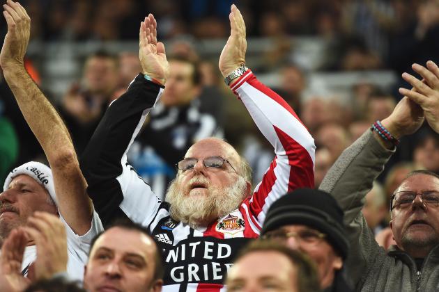 NEWCASTLE UPON TYNE, ENGLAND - DECEMBER 21: A fan supporting both teams applauds during the Barclays Premier League match between Newcastle United and Sunderland at St James' Park on December 21, 2014 in Newcastle upon Tyne, England. (Photo by Laurence Griffiths/Getty Images)