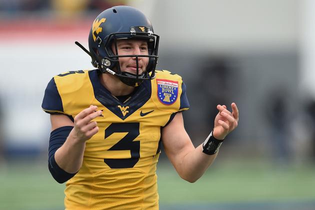 MEMPHIS, TN - DECEMBER 29:  Skyler Howard #3 of the West Virginia Mountaineers celebrates a touchdown against the Texas A&M Aggies during the second quarter of the 56th annual Autozone Liberty Bowl at Liberty Bowl Memorial Stadium on December 29, 2014 in Memphis, Tennessee.  (Photo by Stacy Revere/Getty Images)