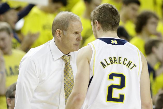 Michigan head coach John Beilein talks with guard Spike Albrecht during the second half of an NCAA college basketball game against Illinois in Ann Arbor, Mich., Tuesday, Dec. 30, 2014. (AP Photo/Carlos Osorio)
