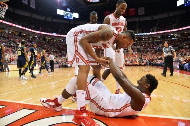 COLUMBUS, OH - JANUARY 13:  Amir Williams #23 of the Ohio State Buckeyes celebrates with Jae'Sean Tate #1 of the Ohio State Buckeyes after Tate's hustle kept the ball inbounds and drew a foul in the second half against the Michigan Wolverines on January 13, 2015 at Value City Arena in Columbus, Ohio. Ohio State defeated Michigan 71-52.  (Photo by Jamie Sabau/Getty Images)