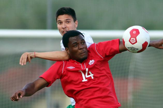 Canada's Cyle Larin, front, challenges for a ball with Ilia Milanov, back, of Bulgaria during a friendly soccer match between Canada and Bulgaria, in Ritzing, Austria, Friday, May 23, 2014. (AP Photo/Ronald Zak)