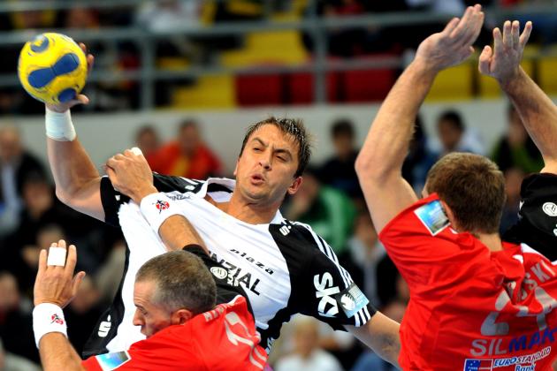 Momir Ilic, center top, of Germany's THW Kiel jumps to hurl the ball over Stevce Alusovski, bottom and Velko Markovski, right, of Macedonia's Vardar PRO during a Group D handball match of the 2009/10 Men's Champions League, in Macedonia's capital Skopje, on Saturday, Oct. 17, 2009. (AP Photo/Boris Grdanoski)