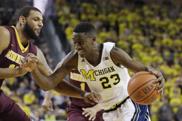 Michigan guard Caris LeVert (23) drives on Minnesota forward Maurice Walker during the second half of an NCAA basketball game, Saturday, Jan. 10, 2015, in Ann Arbor, Mich. Michigan defeated Minnesota 62-57. (AP Photo/Carlos Osorio)