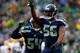 SEATTLE, WA - JANUARY 18: Cliff Avril #56 and Bobby Wagner #54 of the Seattle Seahawks react during the third quarter of the 2015 NFC Championship game against the Green Bay Packers at CenturyLink Field on January 18, 2015 in Seattle, Washington. (Photo by Tom Pennington/Getty Images)