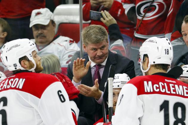 Dec 2, 2014; Raleigh, NC, USA; Carolina Hurricanes coach Bill Peters talks to his players during a 3rd period timeout against the Nashville Predators at PNC Arena. The Carolina Hurricanes defeated the Nashville Predators 2-1. Mandatory Credit: James Guillory-USA TODAY Sports