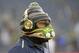 Seattle Seahawks running back Marshawn Lynch walks on the field before an NFL divisional playoff football game against the Carolina Panthers in Seattle, Saturday, Jan. 10, 2015. (AP Photo/Ted S. Warren)
