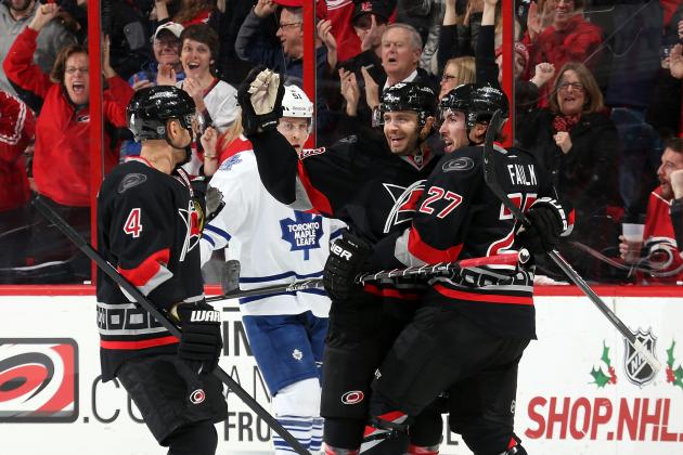 RALEIGH, NC - DECEMBER 18:  Andrej Sekera #4, Patrick Dwyer #39 and Justin Faulk #27 of the Carolina Hurricanes celebrate following Faulk's shorthanded goal in the first period as Jake Gardiner #51 of the Toronto Maple Leafs looks on during an NHL game at PNC Arena on December 18, 2014 in Raleigh, North Carolina.  (Photo by Gregg Forwerck/NHLI via Getty Images)
